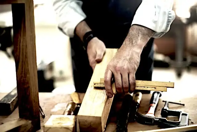 Un homme travaille sur un morceau de vieux bois