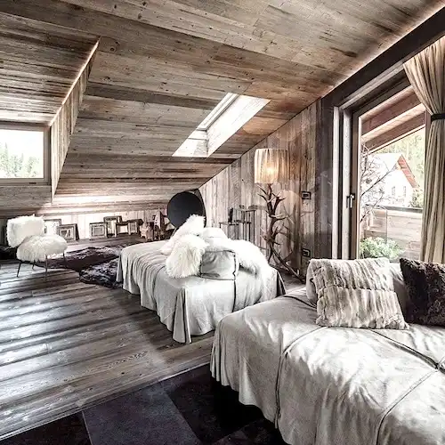  Une chambre avec des murs en lambris bois vieilli et du parquet 