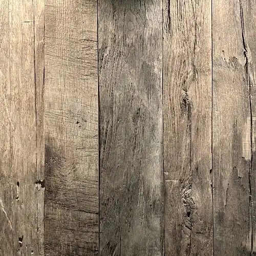 Un gros plan d'un parquet en vieux chêne dans une pièce.