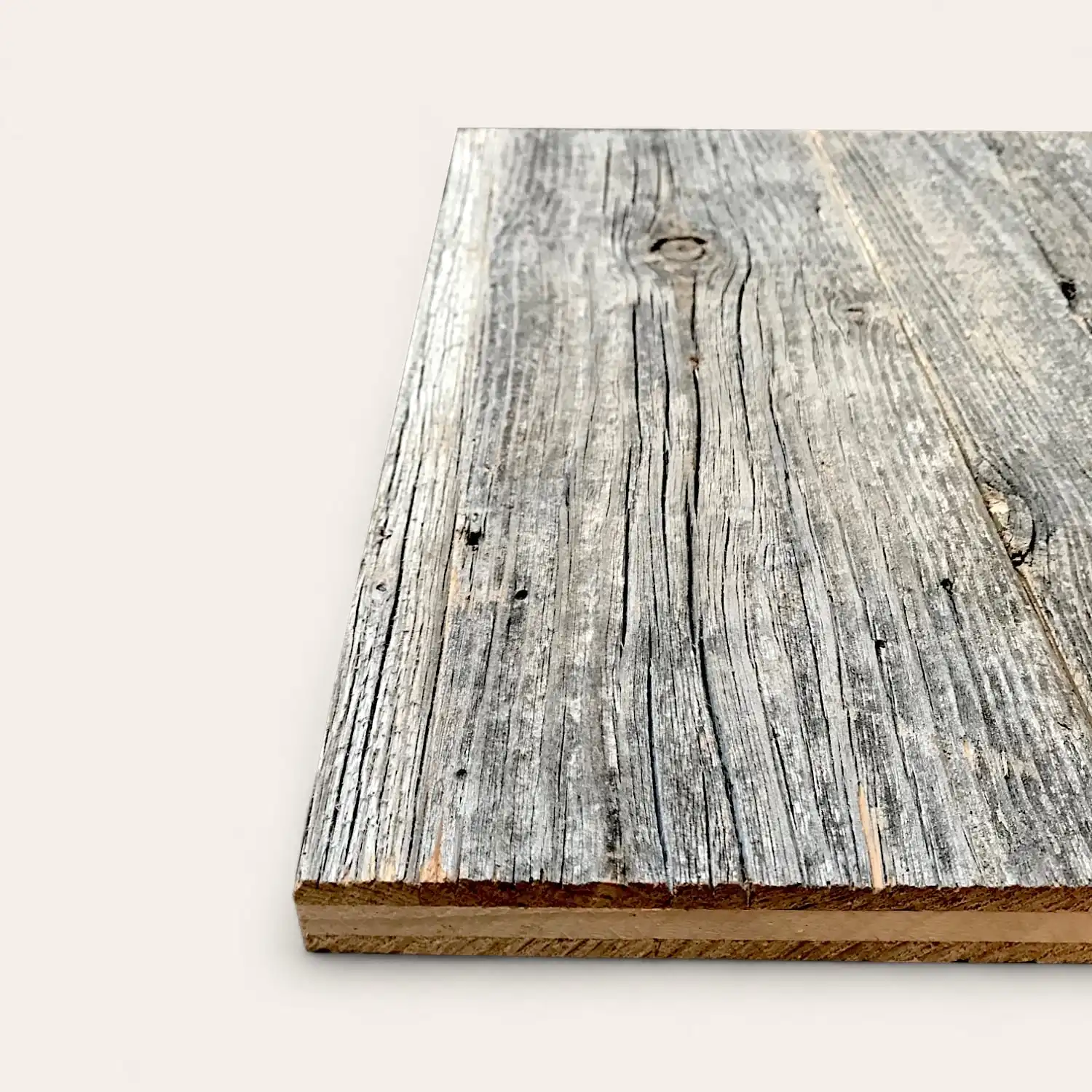  Vue latérale d'une planche de bois avec une surface grise texturée et patinée sur un fond blanc uni. 