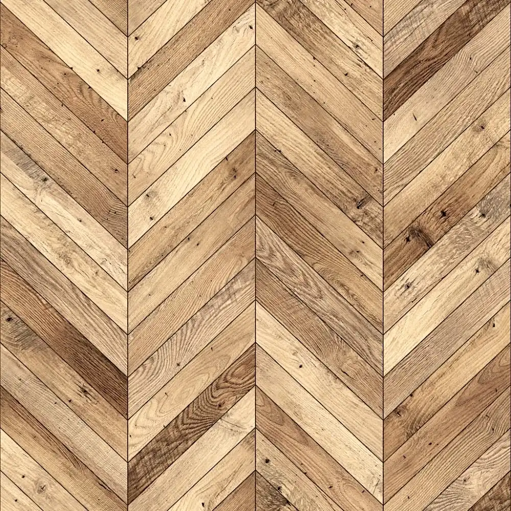  Parquet à chevrons avec alternance de planches de bois clair et foncé. Le grain naturel est visible, ajoutant de la texture au motif géométrique. 